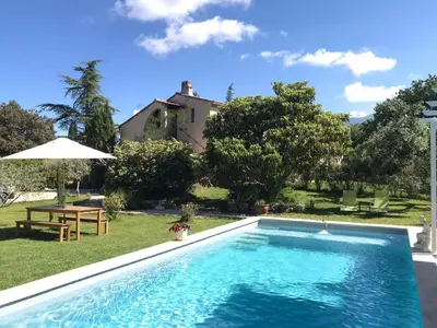 a swimming pool in front of a house at La belle histoire Gîte Ventoux in Bédoin
