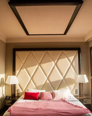 a bedroom with a large bed with two lamps at Le Safari Hotel Restaurant in Carpentras