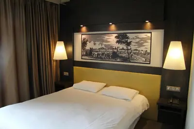 a bedroom with a bed with two white pillows at Le Safari Hotel Restaurant in Carpentras