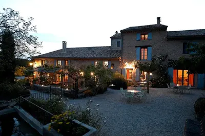 a large house with a courtyard in front of it at Mas des Olives in Bédoin
