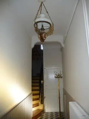 a hallway with a chandelier hanging from a ceiling at Maison Daumas Billard Français et Piscine in Robion en Luberon