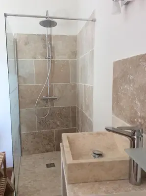 a bathroom with a shower with a sink at Maison Daumas Billard Français et Piscine in Robion en Luberon