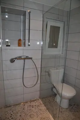 a bathroom with a toilet and a glass shower at La Bignone in LʼIsle-sur-la-Sorgue