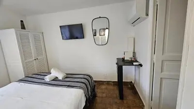 a bedroom with a bed and a mirror on the wall at Mas au Cœur de La Provence & SPA in Saint-Cannat