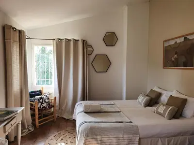 a bedroom with a bed and a window at Mas au Cœur de La Provence & SPA in Saint-Cannat