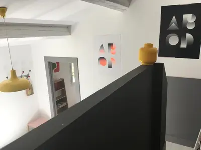 a living room with a tv and a wall at Les cabanes de Vallis Clausa in Saumane-de-Vaucluse