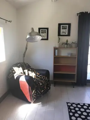 a living room with a lamp and a couch at Les cabanes de Vallis Clausa in Saumane-de-Vaucluse