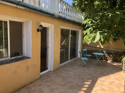 a patio with a table and chairs next to a building at 1001 Ocres in Apt