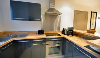 a kitchen with a sink and a counter top at Lagrange Vacances - Le Clos Savornin in Saint-Saturnin-les-Apt