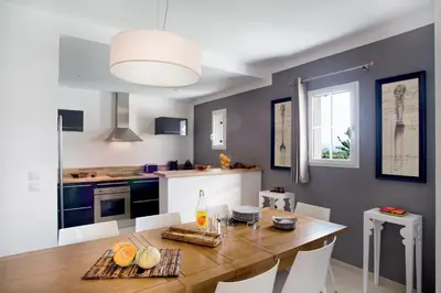 a kitchen and dining room with a table and chairs at Lagrange Vacances - Le Clos Savornin in Saint-Saturnin-les-Apt