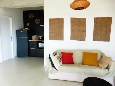 a living room with a couch with colorful pillows on it at Maison Itzé in Saint-Saturnin-les-Apt