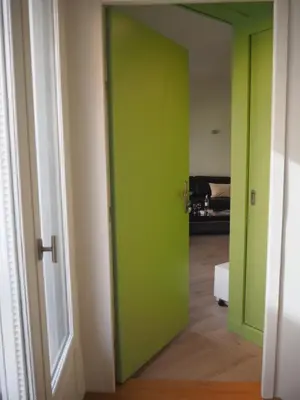 an open door to a room with green walls at APPART AIX MAZARIN in Aix-en-Provence