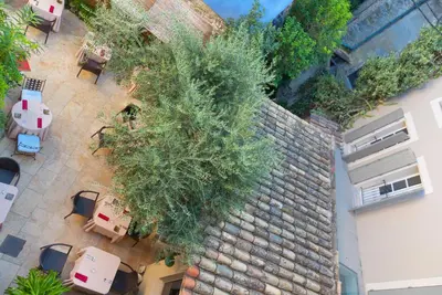 an overhead view of a patio with tables and plants at La Prévôté - Luxury Chambres d'hôtes & Gastronomic Restaurant in LʼIsle-sur-la-Sorgue