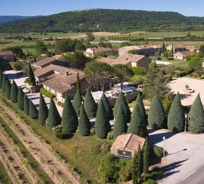 an aerial view of a subdivision with trees at Hôtel Carcarille Restaurant Le C in Gordes