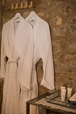 two white sweaters hanging on a wall at La Belugue in Beaumont-de-Pertuis