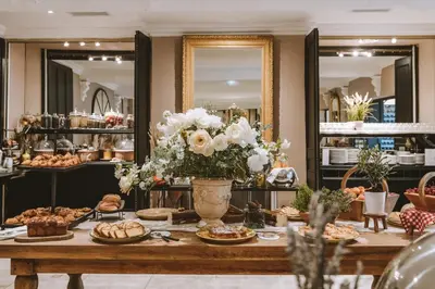 a table with food and flowers in a store at Le Phébus & Spa – Relais & Châteaux in Joucas