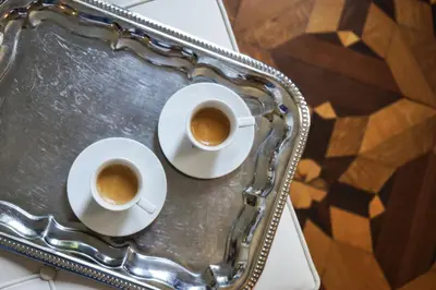 two cups of coffee on a tray on a table at Hôtel Particulier Le 28 - Spa & Art Luxury Design in Aix-en-Provence