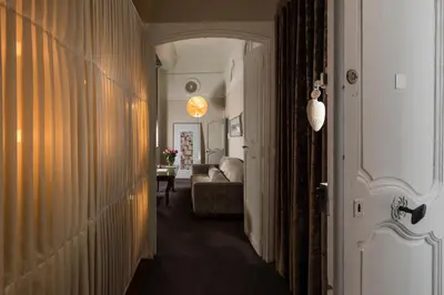 a hallway leading to a living room with a couch at Hôtel Particulier Le 28 - Spa & Art Luxury Design in Aix-en-Provence