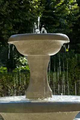 a stone fountain with water coming out of it at Hôtellerie Notre Dame de Lumières in Goult