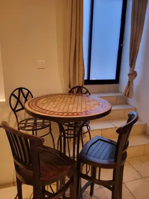 a table and chairs in a room with a window at Gite A.M Hoche in Lançon-Provence