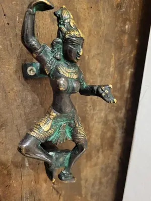 a bronze statue of a woman on a wooden door at Gite A.M Hoche in Lançon-Provence
