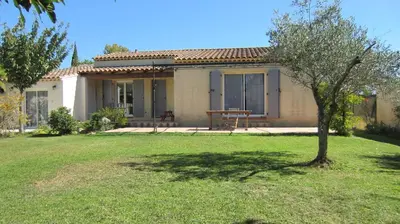 a house with a tree in front of a yard at Studio A Grans in Grans