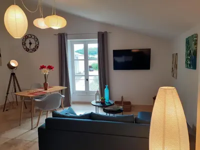 a living room with a couch and a table at L'ARCHIMBAUDE in Pertuis