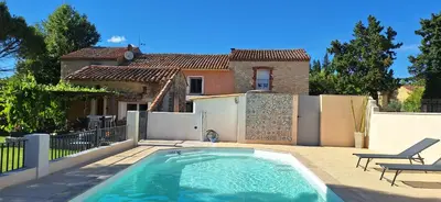 a swimming pool in the backyard of a house at Gîte Mas de la Restanque in Monteux