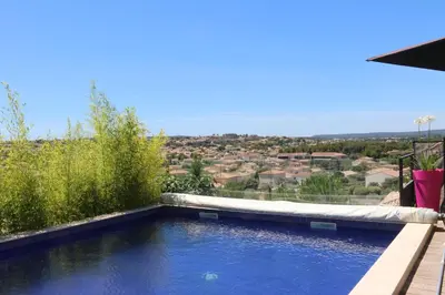 a swimming pool with a view of a city at Belle villa en Provence in Lançon-Provence