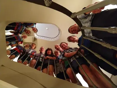 a group of people standing on a ladder in a mirror at Hôtel Le Siècle in Mazan