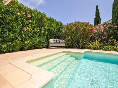 a chair sitting next to a swimming pool at Villa Les Angevines by Interhome in Morières-lès-Avignon