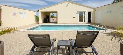 two chairs sitting in front of a swimming pool at Hotel Les Nevons in LʼIsle-sur-la-Sorgue