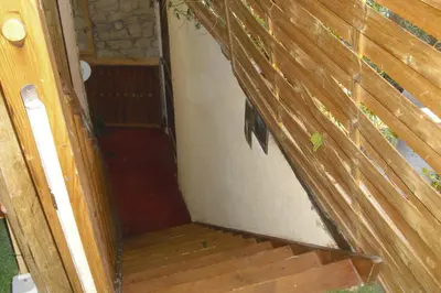 an open door to a porch with a wooden stairs at Lou mas li Pitchoun 
