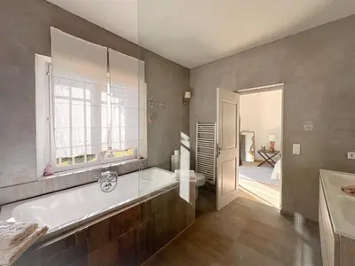 a large bathroom with a tub and a window at Mas La Bellevue in Murs