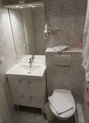 a bathroom with a sink and a toilet and a mirror at Hôtel Vendôme in Aix-en-Provence