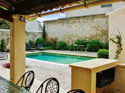 a patio with a table and a swimming pool at Maison de charme à Mollégès avec piscine privée in Mollégès