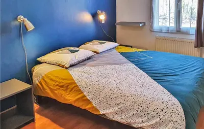 a bed in a room with a blue wall at 4 Bedroom Beautiful Home In Goult in Goult