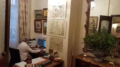 a man sitting at a desk in front of a computer at Hotel Cardinal in Aix-en-Provence