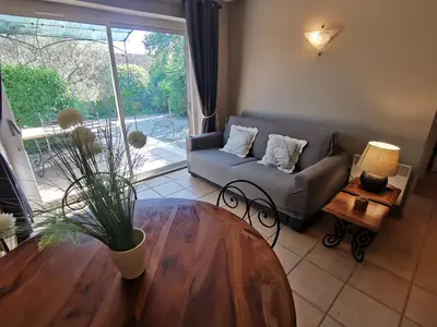 a living room with a couch and a table at Bastidon Provencal in Gordes