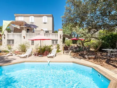 a swimming pool in front of a house at Apartment Mireio by Interhome in Lambesc