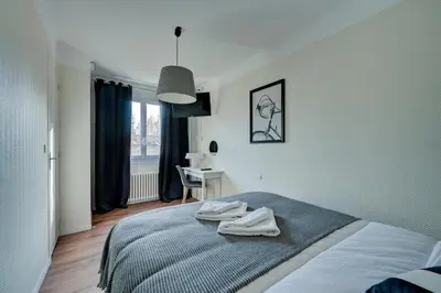 a bedroom with a bed with two towels on it at Hôtel Paul in Aix-en-Provence