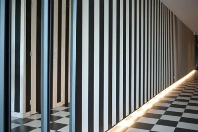 a hallway with a black and white checkered floor at Hôtel Paul in Aix-en-Provence