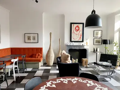 a living room with a couch and a fireplace at Hôtel Paul in Aix-en-Provence