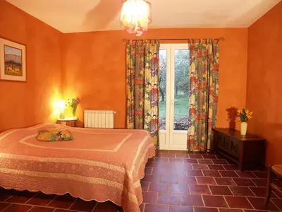 a bedroom with a bed and a large window at Ll POULIDETTO in Lioux