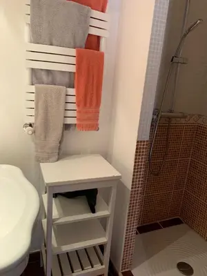 a bathroom with towels on a rack next to a shower at Ll POULIDETTO in Lioux