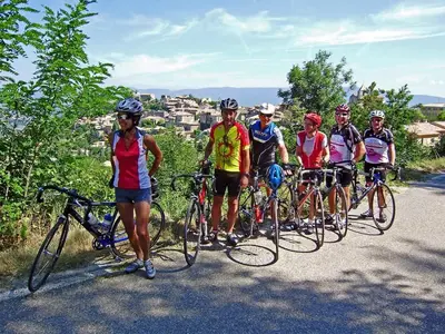 a group of people riding bikes on a road at Ll POULIDETTO in Lioux