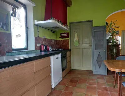a kitchen with a counter and a sink and a table at Maison d'artiste in Gargas