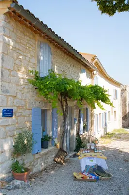 a stone house with a table in front of it at La Bastide des Bourguets Adults Only, Mont Ventoux in Sault-de-Vaucluse