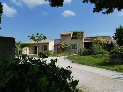 a house in the middle of a driveway at Les Biguières in Maubec