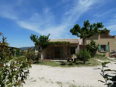 a house with a tree in front of it at Les Biguières in Maubec